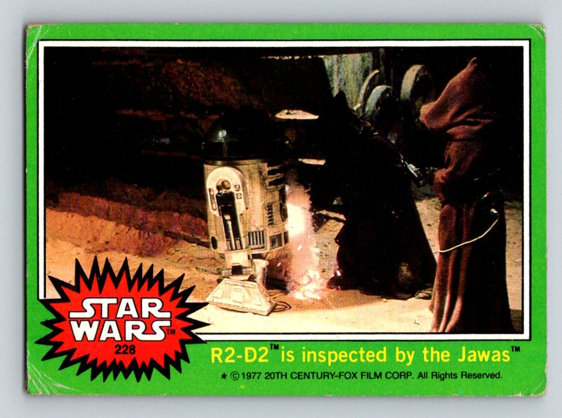 1977 Topps Star Wars #228b R2-D2 is inspected by the Jawas