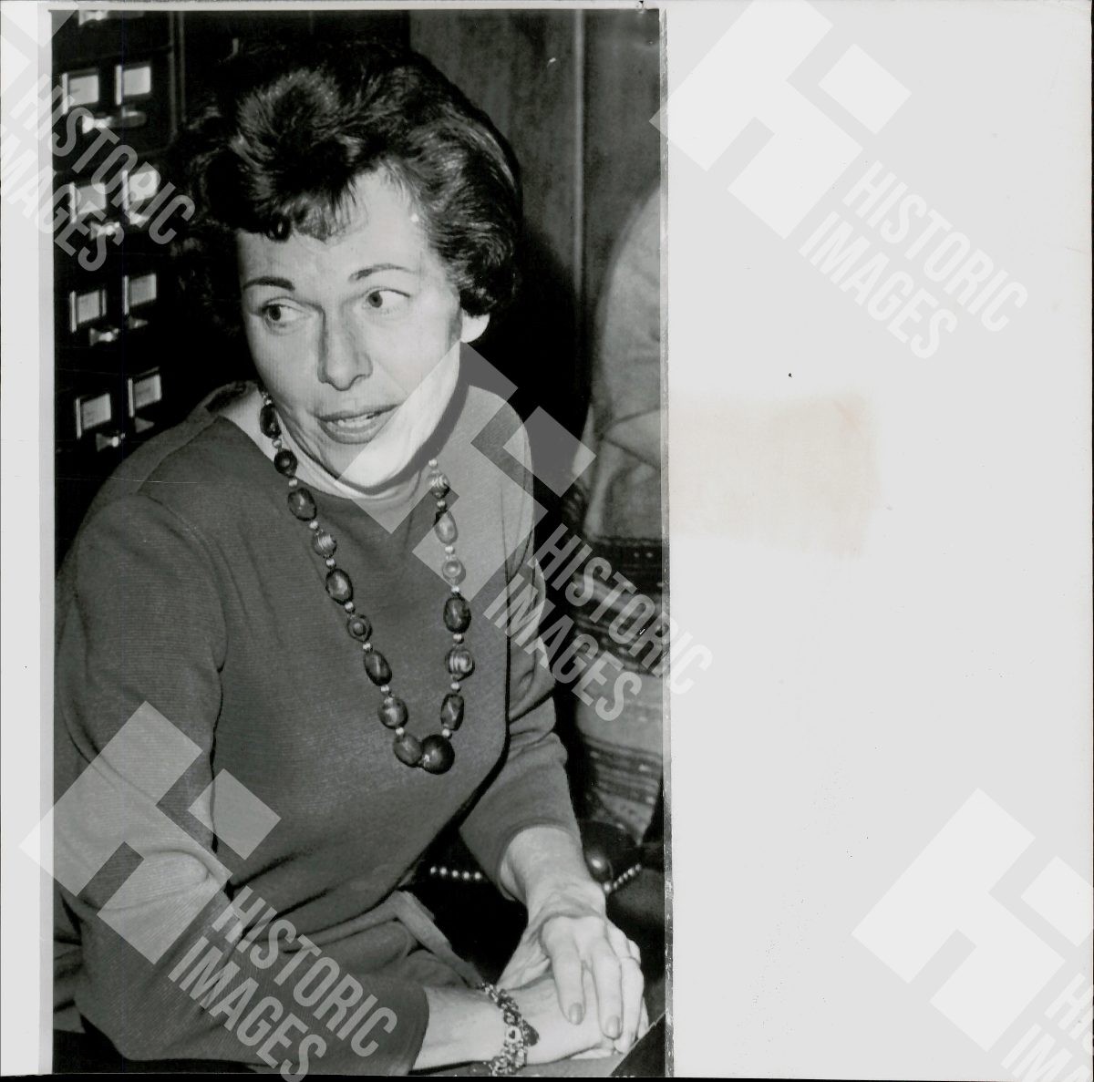 1963 B&W Photo of a woman wearing a necklace and long-sleeved shirt