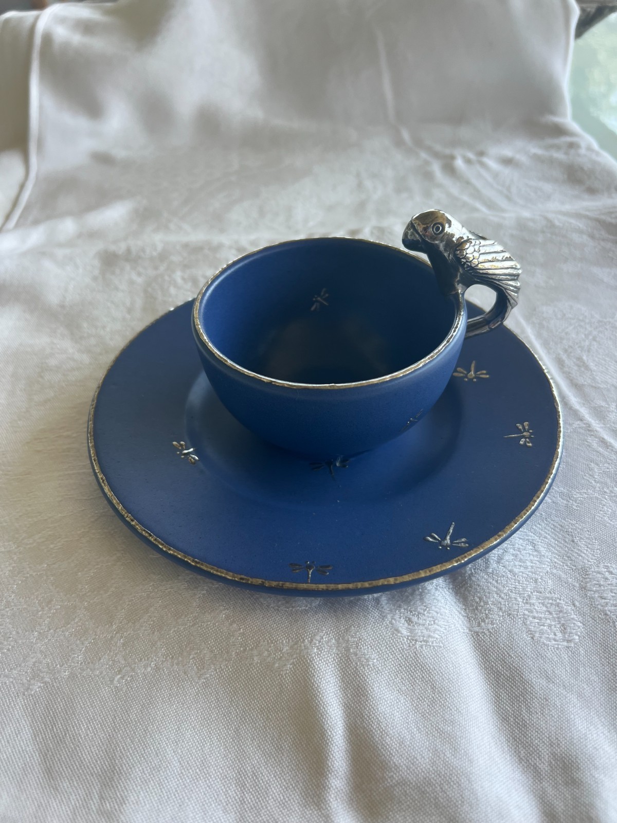 Emilia Castillo cup & saucer blue ceramic w/silver inlay and bird handle